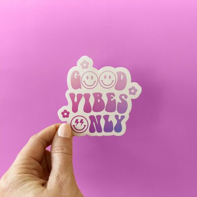 "Good Vibes Only" sticker with retro font and the "O"s as smiley faces. The design is purple gradient and has daisies.