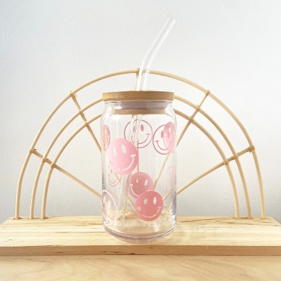 Glass cup with baby pink smilies design on it