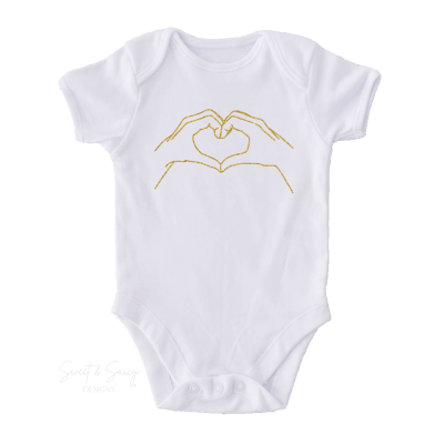 Baby onesie with heart hands from Taylor Swift's Fearless era